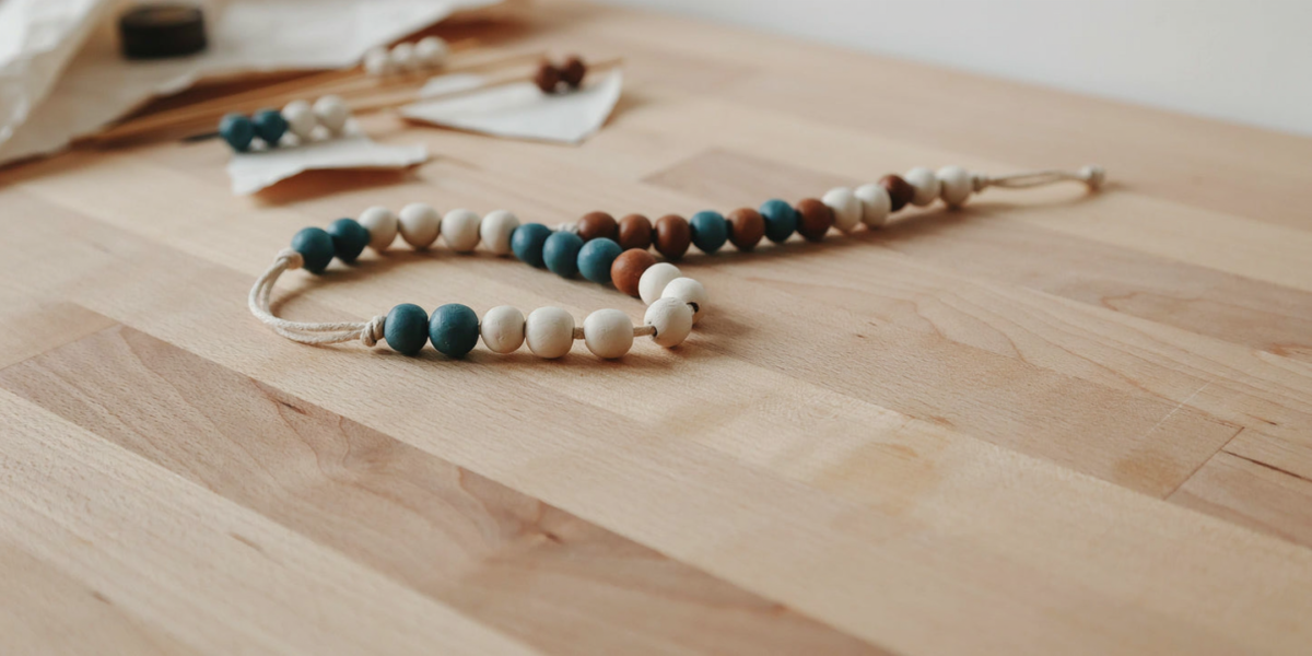 Painted air dry clay beads threaded on cotton cord as a garland