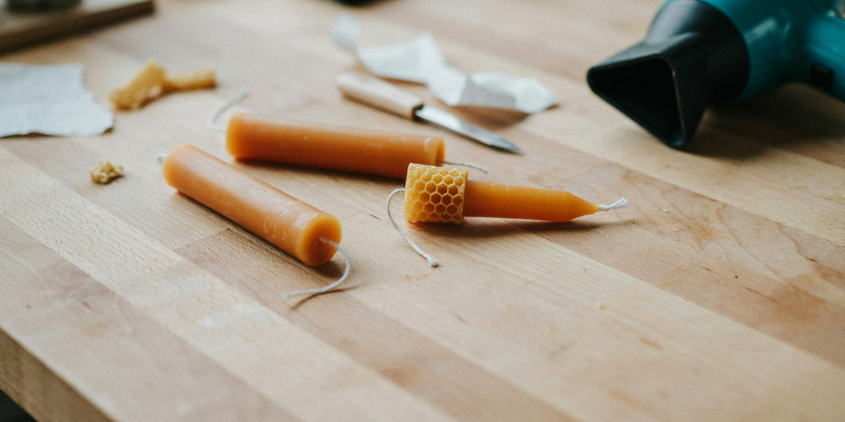 Rolled honeycomb beeswax candles with a sheet of beeswax half rolled