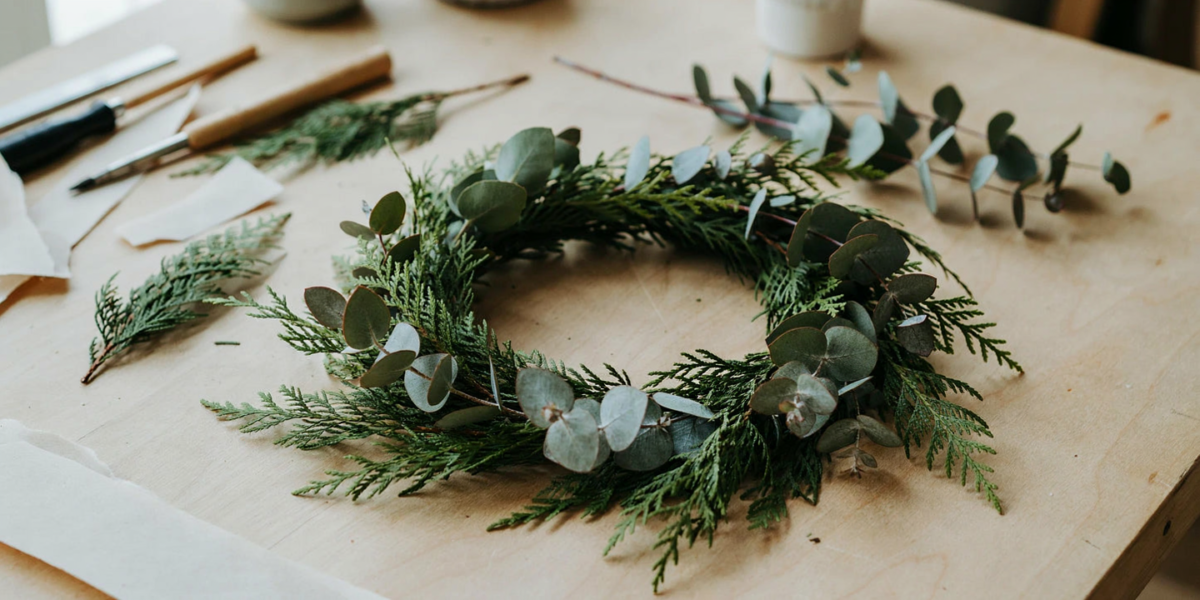 A loose wreath of cedar sprays and silver-blue eucalyptus