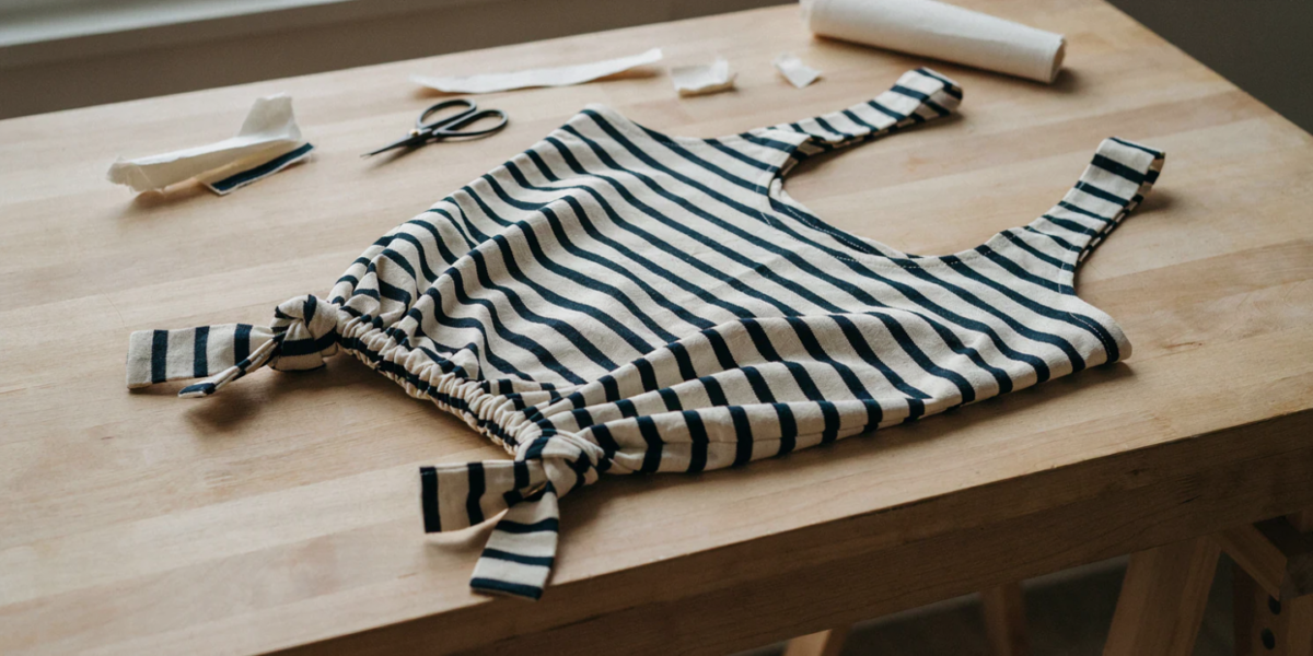 A striped T-shirt turned into a tote bag with a knotted fringe bottom